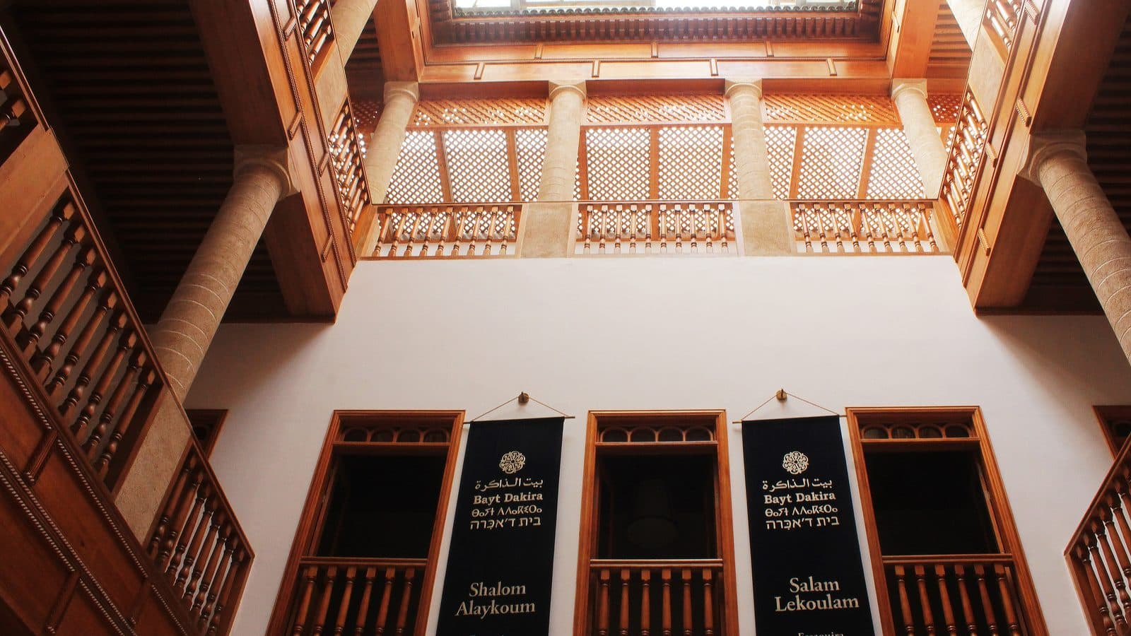 Wooden galleries and banners in the courtyard of Bayt Dakira, the house of memory in Essaouira