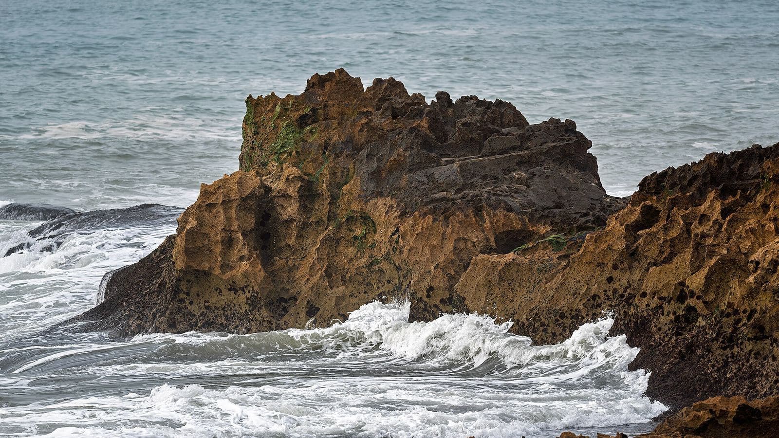 Atlantic waves breaking against dark rocks on the wild coast near Essaouira