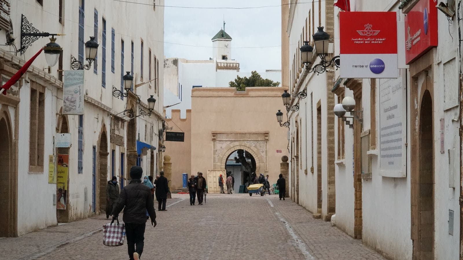 A pedestrian street leading to a stone gate in the medina of Essaouira