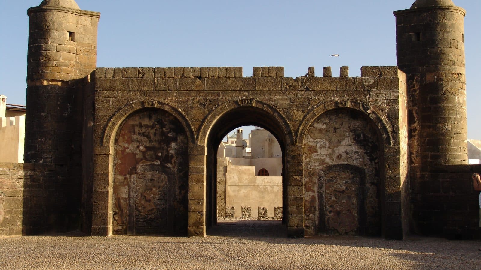 The stone gateway and twin towers of a bastion on the Skala ramparts of Essaouira in the evening light