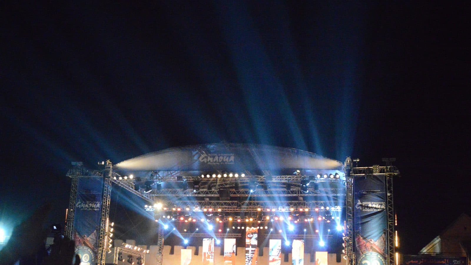 The illuminated main stage of the Gnaoua festival on Place Moulay Hassan in Essaouira at night