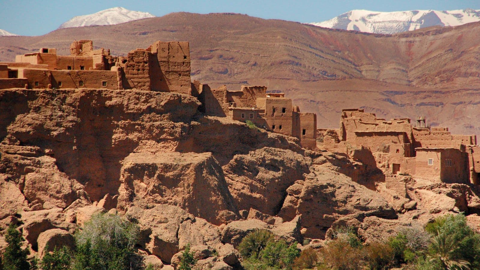 An earth-built kasbah below the snow-capped High Atlas in southern Morocco