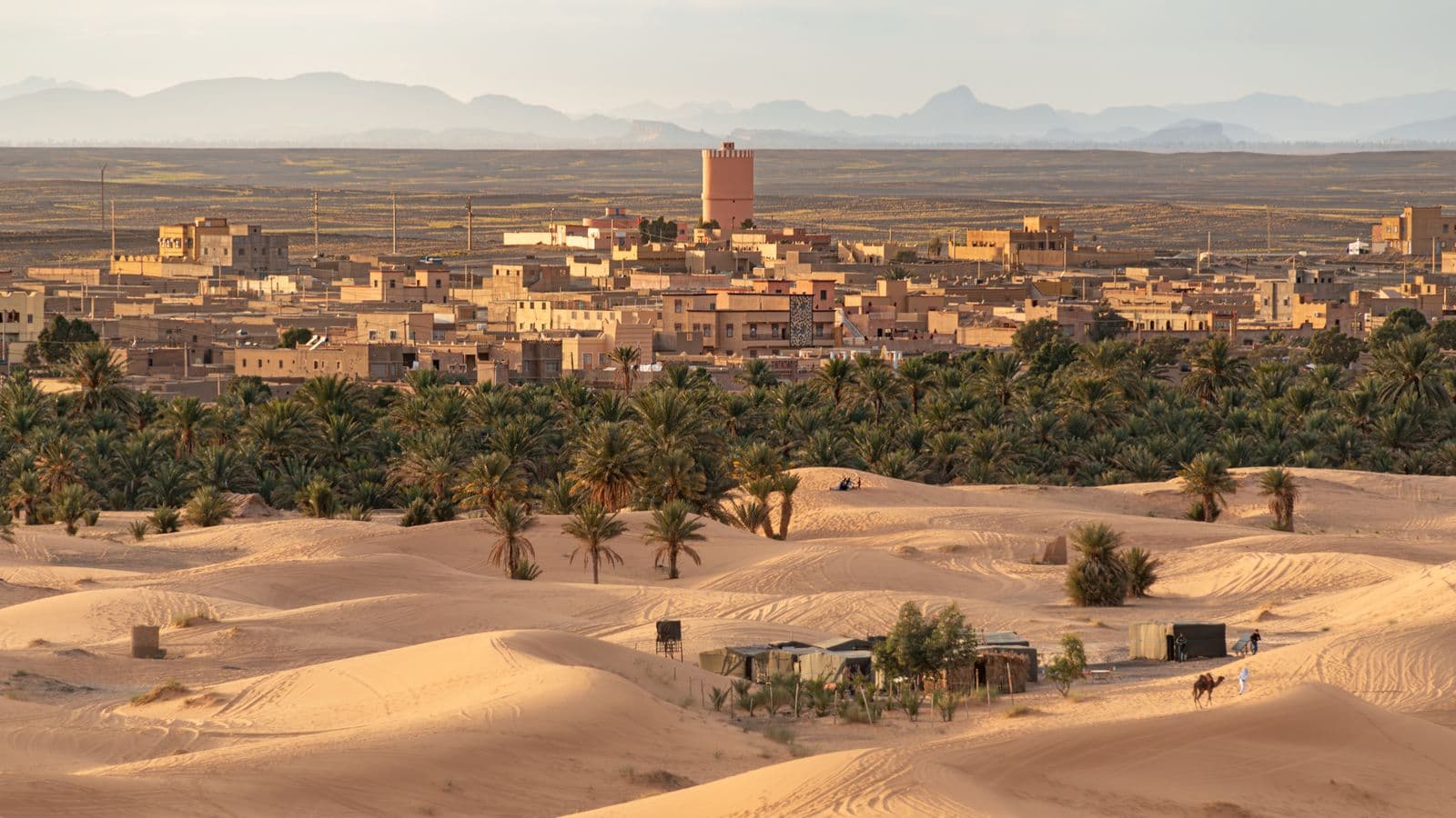 The village of Merzouga and its palm grove at the foot of the golden Erg Chebbi dunes