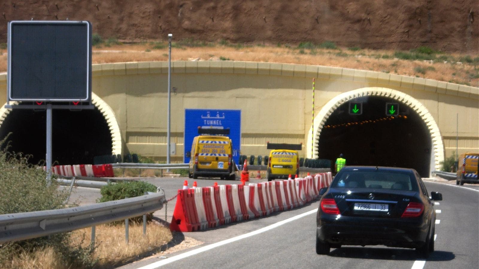 A car approaching the tunnels of a motorway through the mountains of Morocco