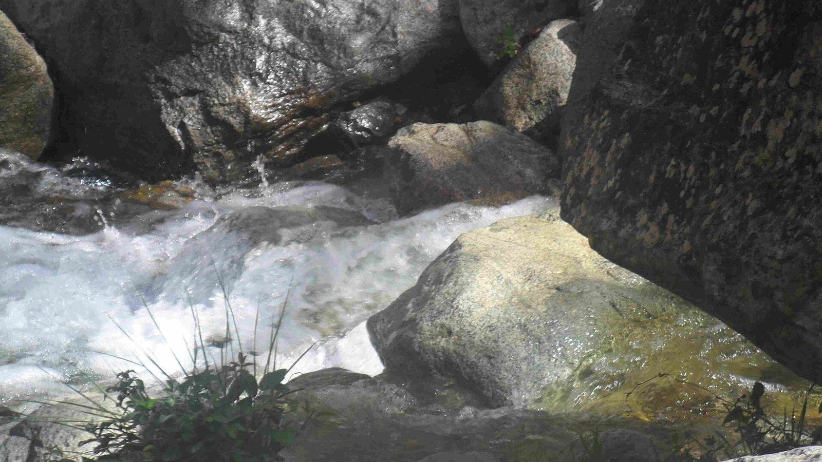White water rushing between boulders on the path to the Setti Fatma waterfalls
