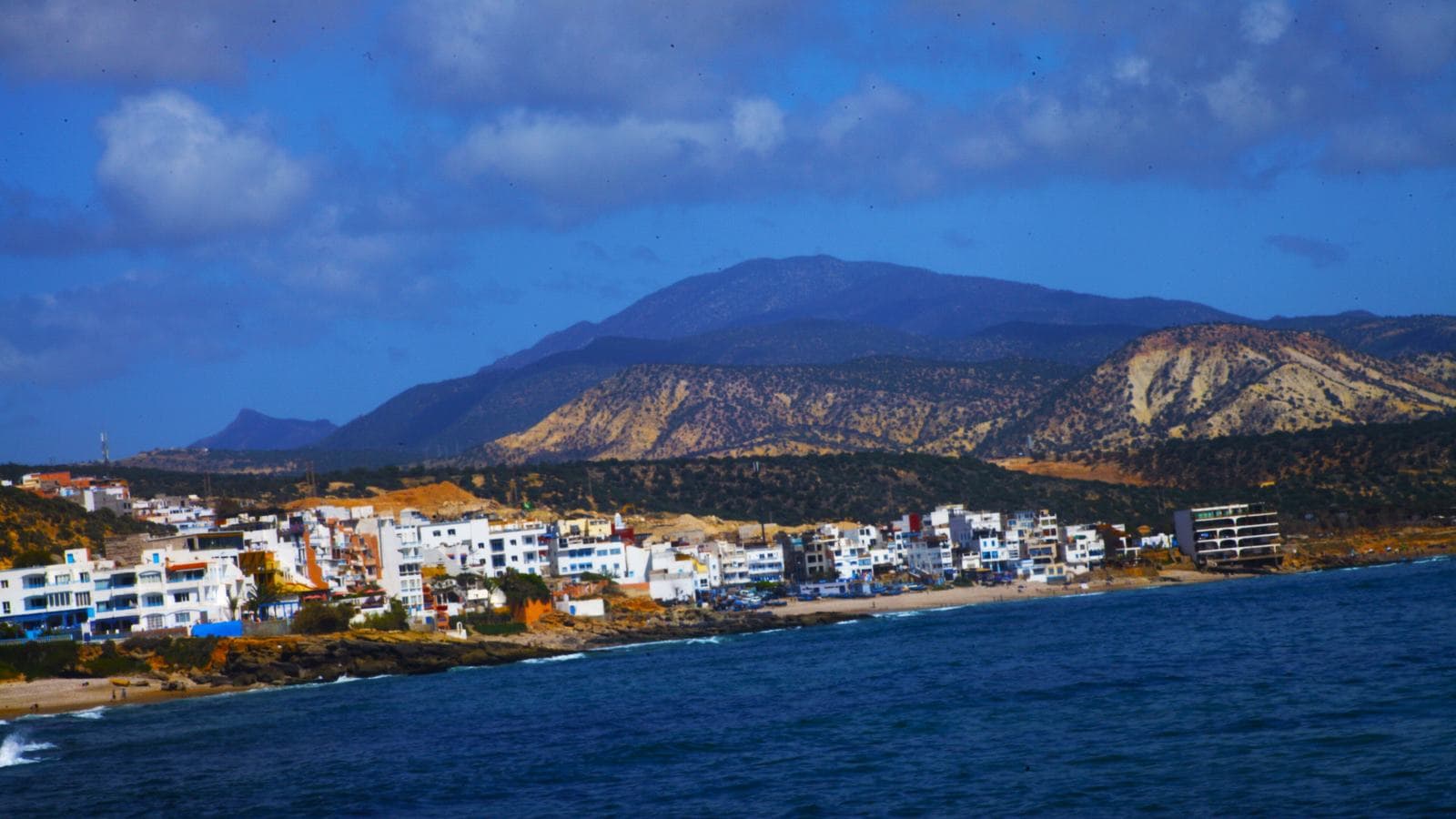 The bay and white houses of Taghazout below the mountains on the coast road north of Agadir