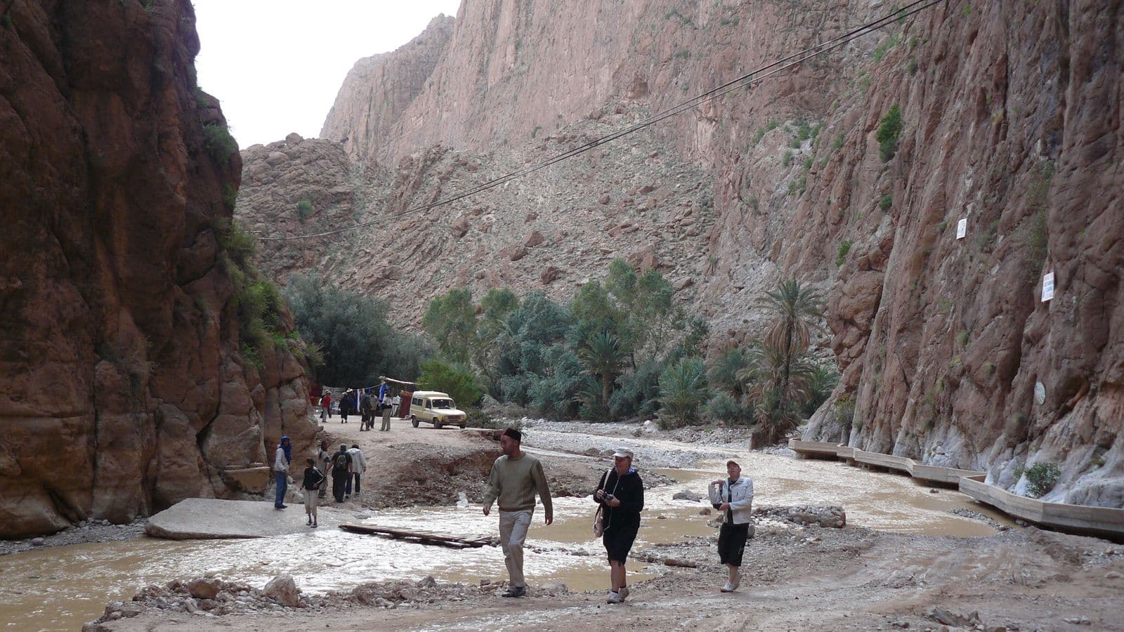 Walkers in the narrow passage of the Todra gorge between towering rock walls