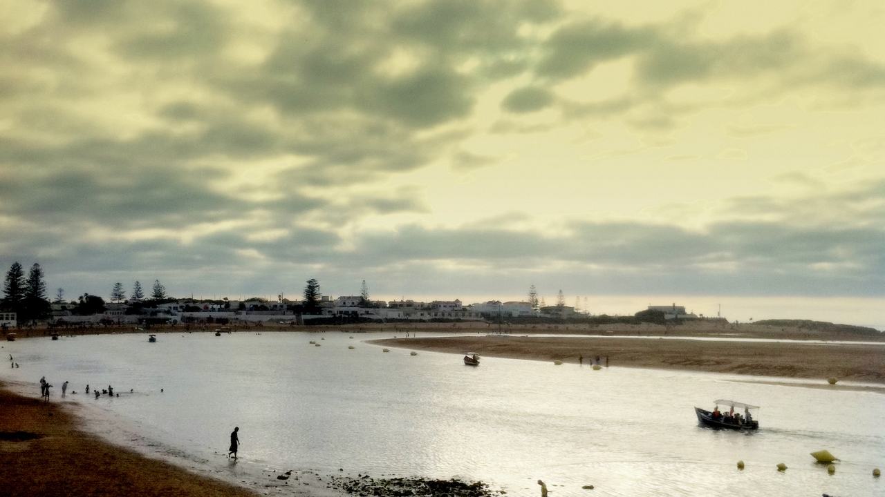 The calm lagoon of Oualidia at low tide with a small boat