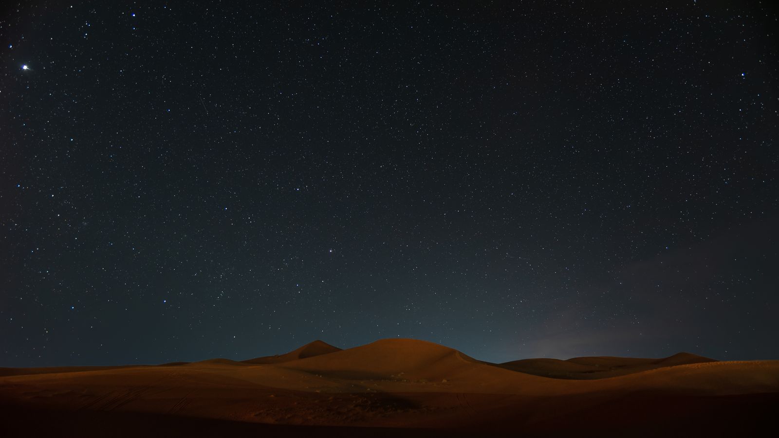 The night sky full of stars over the dunes of the Sahara